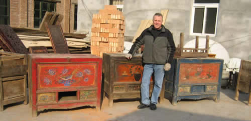 Harry Stryer with antique chests before restoration